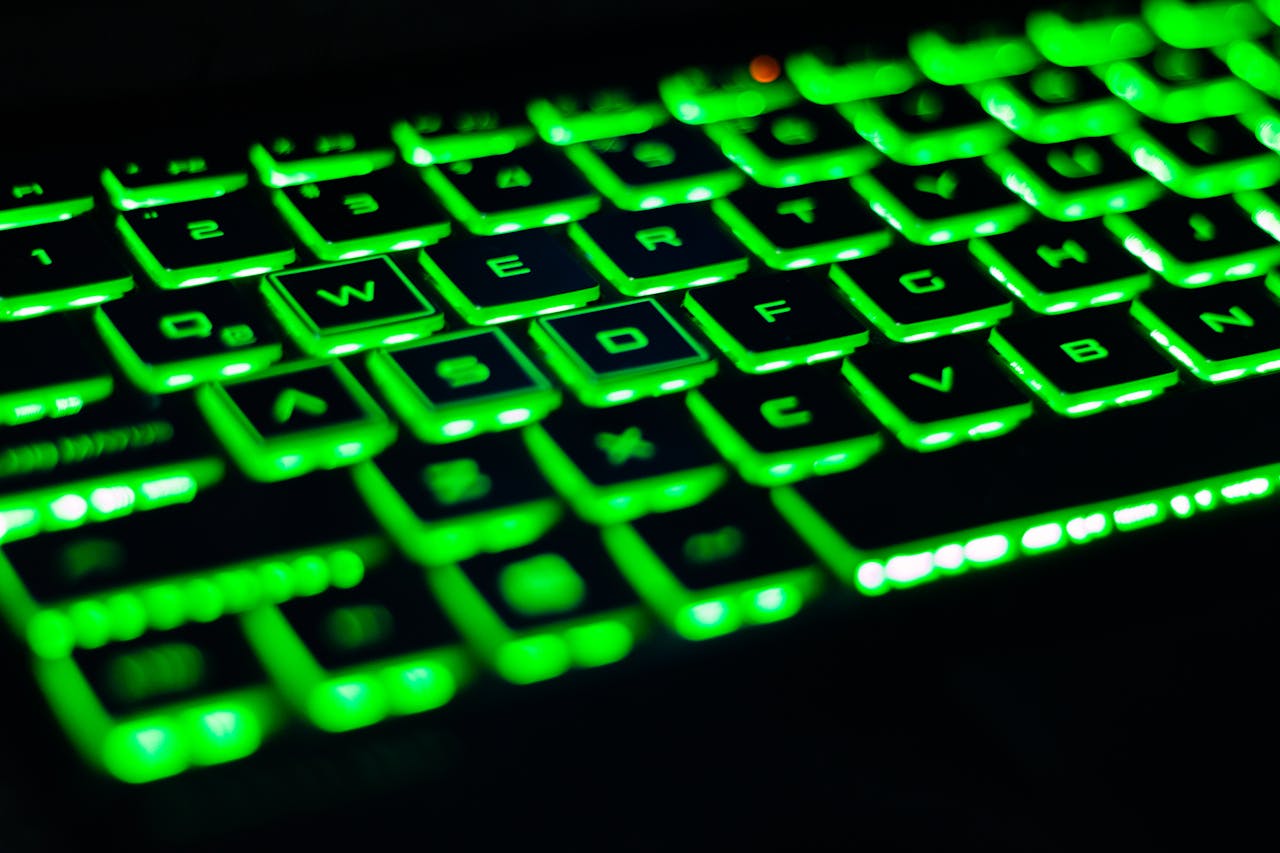 Vibrant green backlit keyboard with visible QWERTY layout. Perfect for tech-related visuals.